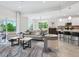 Spacious living room seamlessly connects to an open kitchen with bar seating and modern finishes at 7387 Divot Loop # 15-D, Lakewood Ranch, FL 34202