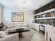 Stylish living room with modern lighting, comfortable seating, and built-in shelves at 7387 Divot Loop # 15-D, Lakewood Ranch, FL 34202