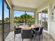 Inviting patio with round table, seating and screened enclosure at 7387 Divot Loop # 15-D, Lakewood Ranch, FL 34202
