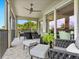 Relaxing outdoor patio with comfortable seating, fan and screened views at 7387 Divot Loop # 15-D, Lakewood Ranch, FL 34202