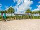 Relaxing pool area with shaded pergola, lounge chairs, and palm trees at 7387 Divot Loop # 15-D, Lakewood Ranch, FL 34202