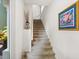 Bright staircase with neutral carpet, white walls, and decorative accents at 7387 Divot Loop # 15-D, Lakewood Ranch, FL 34202