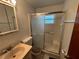 Bathroom featuring a shower with sliding glass doors and a beige sink at 7555 15Th N St, St Petersburg, FL 33702