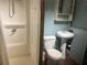 Bathroom featuring a walk-in shower, toilet, and pedestal sink at 7555 15Th N St, St Petersburg, FL 33702