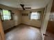 Bedroom with ceiling fan, linoleum floors, and natural light through windows at 7555 15Th N St, St Petersburg, FL 33702