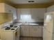 A kitchen featuring white cabinets and appliances at 7555 15Th N St, St Petersburg, FL 33702