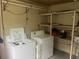 Laundry room with washer, dryer, and shelving at 7555 15Th N St, St Petersburg, FL 33702