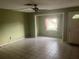 Spacious living room with a ceiling fan and tile flooring at 7555 15Th N St, St Petersburg, FL 33702