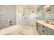 Luxurious bathroom with marble tile, a freestanding tub, a walk-in shower, and modern fixtures at 8006 20Th W Pl, Bradenton, FL 34209