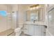 Elegant bathroom featuring a glass-enclosed shower, round window, and stylish vanity at 8006 20Th W Pl, Bradenton, FL 34209