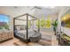A bright bedroom featuring a four-poster bed, ample natural light, and stylish decor at 8006 20Th W Pl, Bradenton, FL 34209