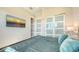 Comfortable bedroom with a TV, closet with frosted glass doors, and beach themed wall art at 8006 20Th W Pl, Bradenton, FL 34209