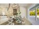 Elegant dining room with seating for six, stylish decor, and sliding glass doors to the outdoor pool area at 8006 20Th W Pl, Bradenton, FL 34209