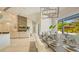 Bright dining area with a view of the pool, showcasing a modern chandelier and open floor plan at 8006 20Th W Pl, Bradenton, FL 34209
