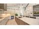 Modern, spacious kitchen featuring white cabinets, stainless steel appliances, and a large island with pendant lighting at 8006 20Th W Pl, Bradenton, FL 34209