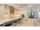 Gourmet kitchen featuring white cabinets, a large island with seating, pendant lighting, and stainless steel appliances at 8006 20Th W Pl, Bradenton, FL 34209