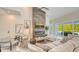 Bright open living room with a fireplace, modern furnishings, and sliding glass doors to the outdoor living space at 8006 20Th W Pl, Bradenton, FL 34209