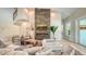 Inviting living room featuring a modern fireplace, comfortable seating, and an open layout with plenty of natural light at 8006 20Th W Pl, Bradenton, FL 34209