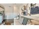 Bright living room with a comfortable sofa, modern art, and view of a wet bar at 8006 20Th W Pl, Bradenton, FL 34209
