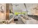 Bright open living room with a fireplace, modern furnishings, and sliding glass doors to the outdoor living space at 8006 20Th W Pl, Bradenton, FL 34209
