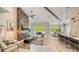 Stylish living room with a modern fireplace, comfortable seating, and an open layout to the kitchen and dining areas at 8006 20Th W Pl, Bradenton, FL 34209