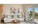 Bright living room with a comfortable sofa, modern art, and sliding doors to a deck at 8006 20Th W Pl, Bradenton, FL 34209