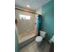 A bathroom featuring a tub with shower, a toilet, and tile flooring at 853 Albritton Ave, Sarasota, FL 34232