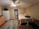 This bedroom features wood-look floors, and a refrigerator with a ceiling fan at 853 Albritton Ave, Sarasota, FL 34232