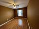 Bright bedroom with wood-look laminate flooring, neutral paint, and a sunny window at 853 Albritton Ave, Sarasota, FL 34232