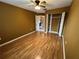 This empty bedroom features a ceiling fan, hardwood floors, and a closet with shelving at 853 Albritton Ave, Sarasota, FL 34232