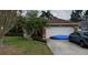 Charming single-story home with a two-car garage, mature landscaping, and well-manicured lawn at 853 Albritton Ave, Sarasota, FL 34232