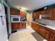 Well-lit kitchen featuring tile floors, wood cabinets, and modern appliances at 853 Albritton Ave, Sarasota, FL 34232