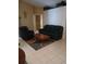 Inviting living room with tile flooring, a comfortable sofa, and a cozy accent chair at 853 Albritton Ave, Sarasota, FL 34232