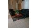 Inviting living room with tile flooring, a comfortable sofa, and a cozy accent chair at 853 Albritton Ave, Sarasota, FL 34232