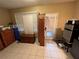 Cluttered room with tile flooring, a window, and a back door with mini blinds at 853 Albritton Ave, Sarasota, FL 34232