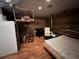 This room features a refrigerator, a bed, a desk, and wood-look floors at 853 Albritton Ave, Sarasota, FL 34232