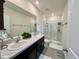 Modern bathroom with double sinks, walk-in glass shower, and neutral color scheme at 8995 Milestone Dr, Sarasota, FL 34238