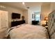 Relaxing bedroom offering a TV, dresser, and a cozy reading space near a window with natural light at 8995 Milestone Dr, Sarasota, FL 34238
