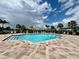 Resort-style swimming pool surrounded by lush landscaping and ample lounge chairs at 8995 Milestone Dr, Sarasota, FL 34238