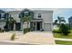 Townhome with a one-car garage, neat landscaping, and a manicured lawn in a well-kept community at 8995 Milestone Dr, Sarasota, FL 34238