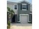 Charming townhome showcasing a one-car garage and a front entrance walkway, with a neatly landscaped yard at 8995 Milestone Dr, Sarasota, FL 34238