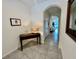 Inviting hallway with decorative table and mirror, showcasing a view into the dining area at 8995 Milestone Dr, Sarasota, FL 34238