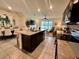 Spacious kitchen island with granite counters and adjacent to dining and living room at 8995 Milestone Dr, Sarasota, FL 34238