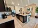 Spacious kitchen featuring dark cabinetry, granite countertops, stainless steel appliances, and tile flooring at 8995 Milestone Dr, Sarasota, FL 34238