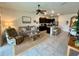 Open-concept living room and kitchen area featuring a dining table, television and seating arrangement at 8995 Milestone Dr, Sarasota, FL 34238