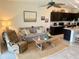 Open-concept living room and kitchen area featuring a dining table, television and seating arrangement at 8995 Milestone Dr, Sarasota, FL 34238