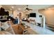 Open-concept living room and kitchen area featuring a dining table, television and staircase at 8995 Milestone Dr, Sarasota, FL 34238