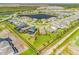 Expansive aerial view showcasing a large backyard, nearby lake, and the surrounding neighborhood at 9292 Tequila Sunrise Dr, Sarasota, FL 34241