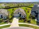 Aerial view of home surrounded by lush green lawn and mature landscaping, offering great curb appeal at 9292 Tequila Sunrise Dr, Sarasota, FL 34241