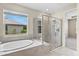 Modern bathroom showcasing a soaking tub and a separate glass-enclosed shower at 9292 Tequila Sunrise Dr, Sarasota, FL 34241